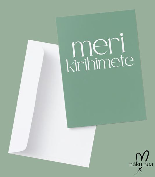 Te Reo Māori Christmas card in sage green, reads Meri Kirihimete on the front in white font. It is presented with a white envelope.