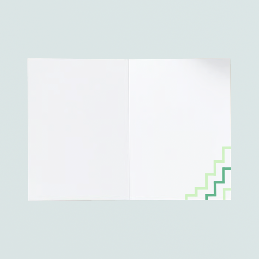 Green Birthday te reo Māori Card reads "Hari Huritau" on the front and has a white and green Poutama design on the bottom right hand corner. It is pictured in front of a white envelope.